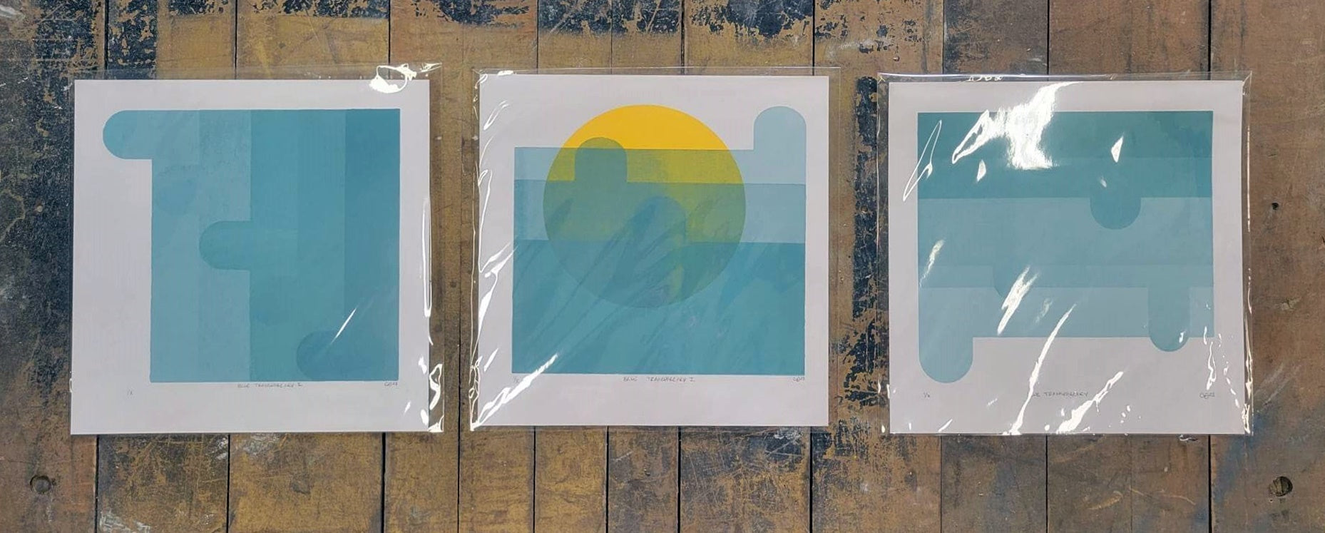 Set of three Blue Transparency I, II, III screen prints  by Claire Davis on vinyl by InkBird; geometric shapes, yellow semicircle center print.