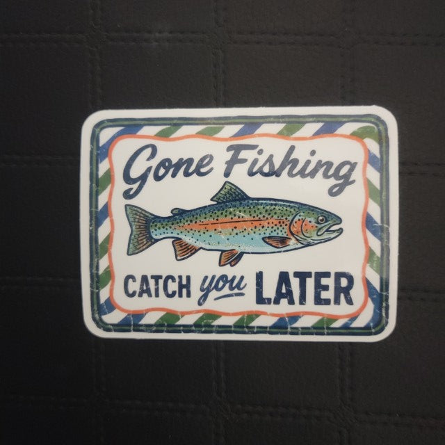 Colorful vinyl die cut sticker by InkBird Print Studio LLC, featuring a fish, “Gone Fishing” text, white background, striped border. Printed for Good Days Marina