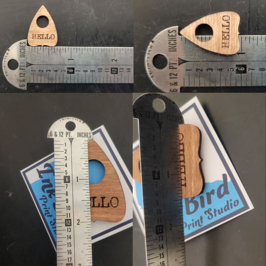 Laser-cut wood Planchette Pin by InkBird Print Studio, guitar pick shape, HELLO text, large/small size shown with ruler.