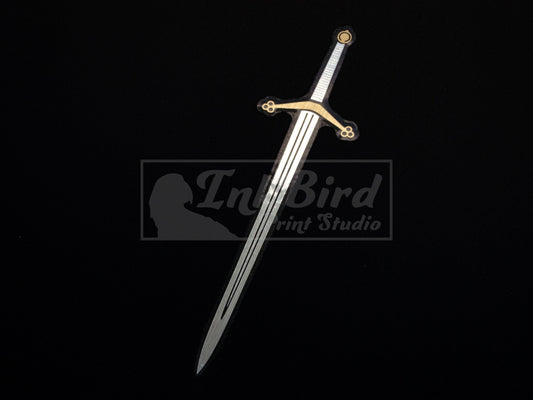 Vinyl sticker of a Scottish Claymore by InkBird Print Studio, metallic silver blade and gold crossguard on black background.
