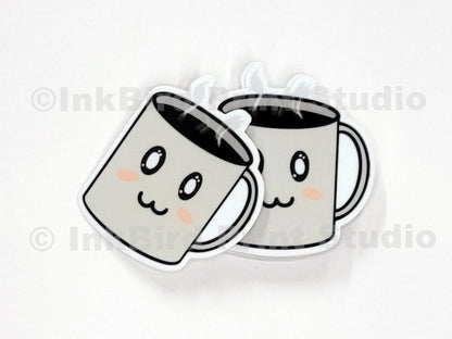 Vinyl coffee cup sticker by InkBird Print Studio with two cartoon mugs, rosy cheeks, clinking, and steamy details; die-cut, adhesive-backed.